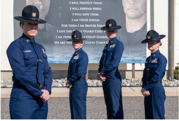 Group of USCG women standing in front of a landmark